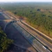 Aerial view of the ViaCon Group's infrastructure project featuring a bridge and culvert solution over a highway, surrounded by lush greenery.